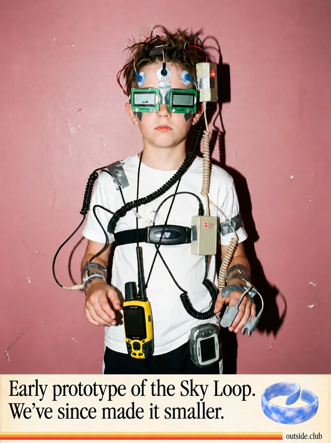 Poster: a boy covered in taped-on gadgets, wires, sensors, chest straps and screens. Early prototype of the Sky Loop. We’ve since made it smaller.